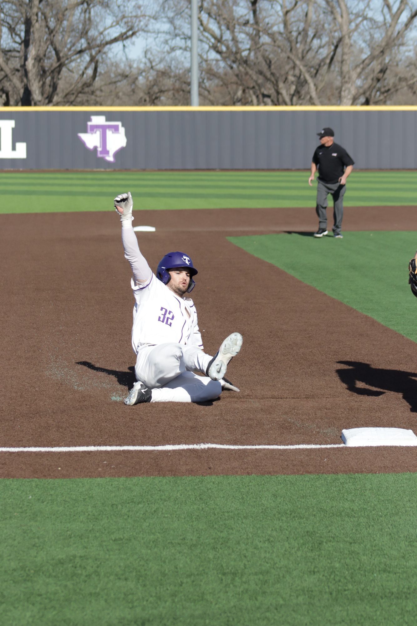 Baseball player sliding into base