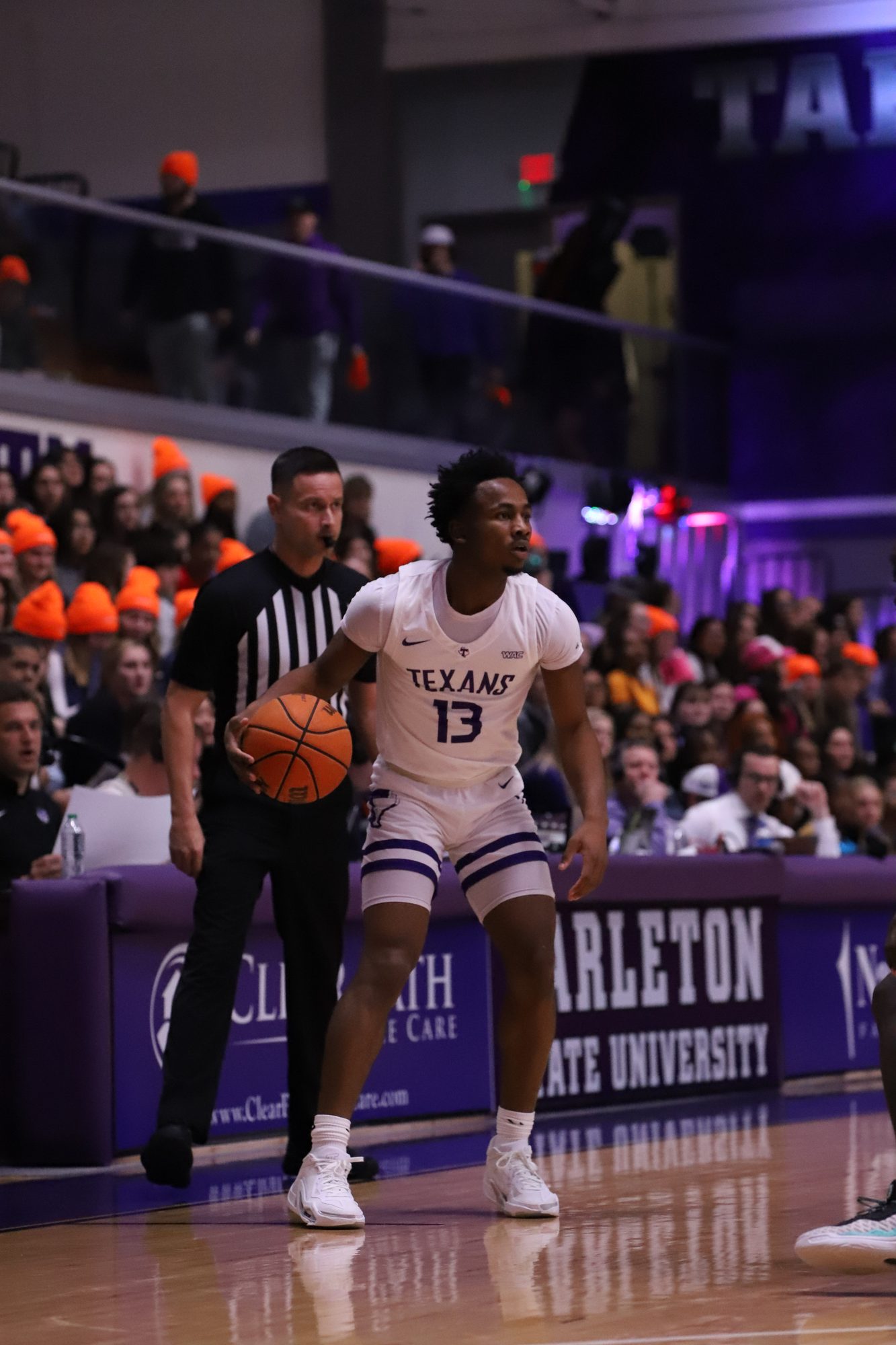 Basketball player dribbling up the court