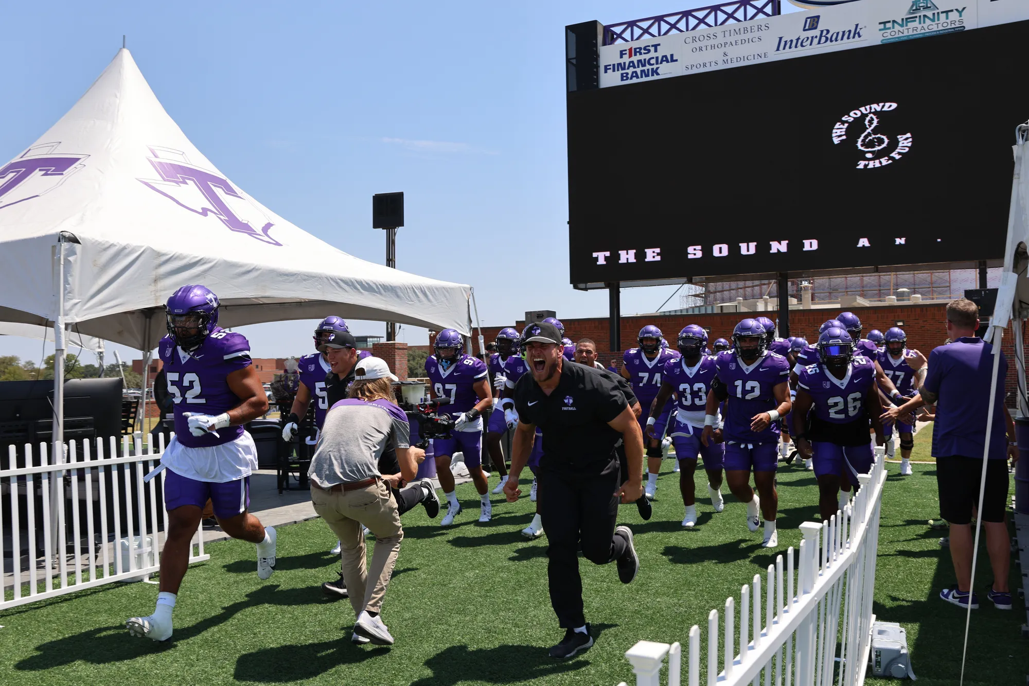 Tarleton football team running onto the field