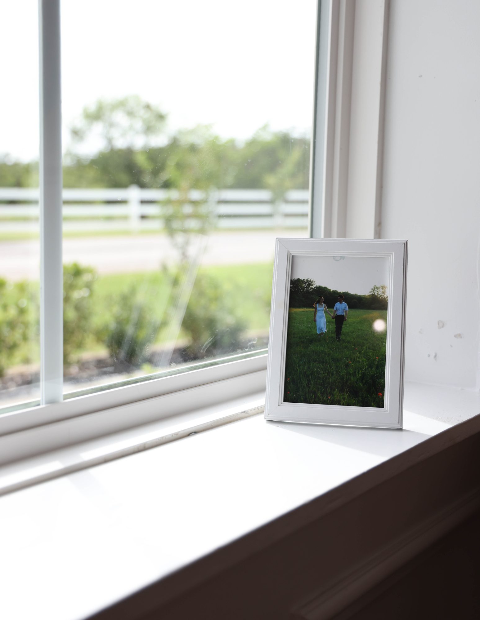 Framed photo of the couple on a sunny windowsill