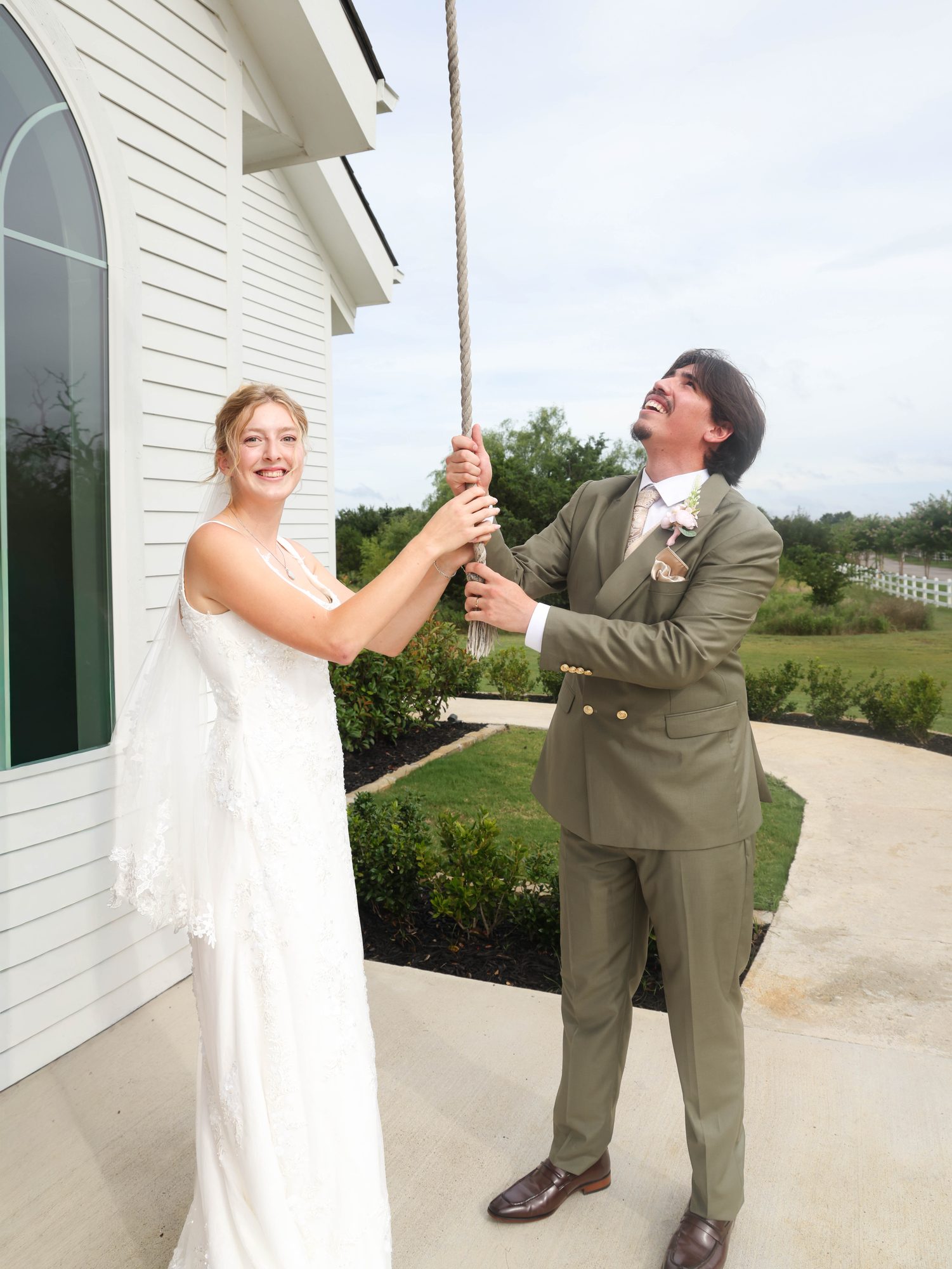 Bride and groom ringing the chapel bell together