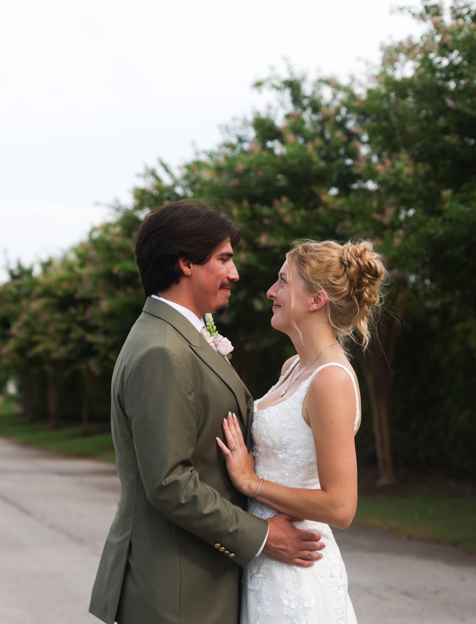 Bride and groom embracing outdoors
