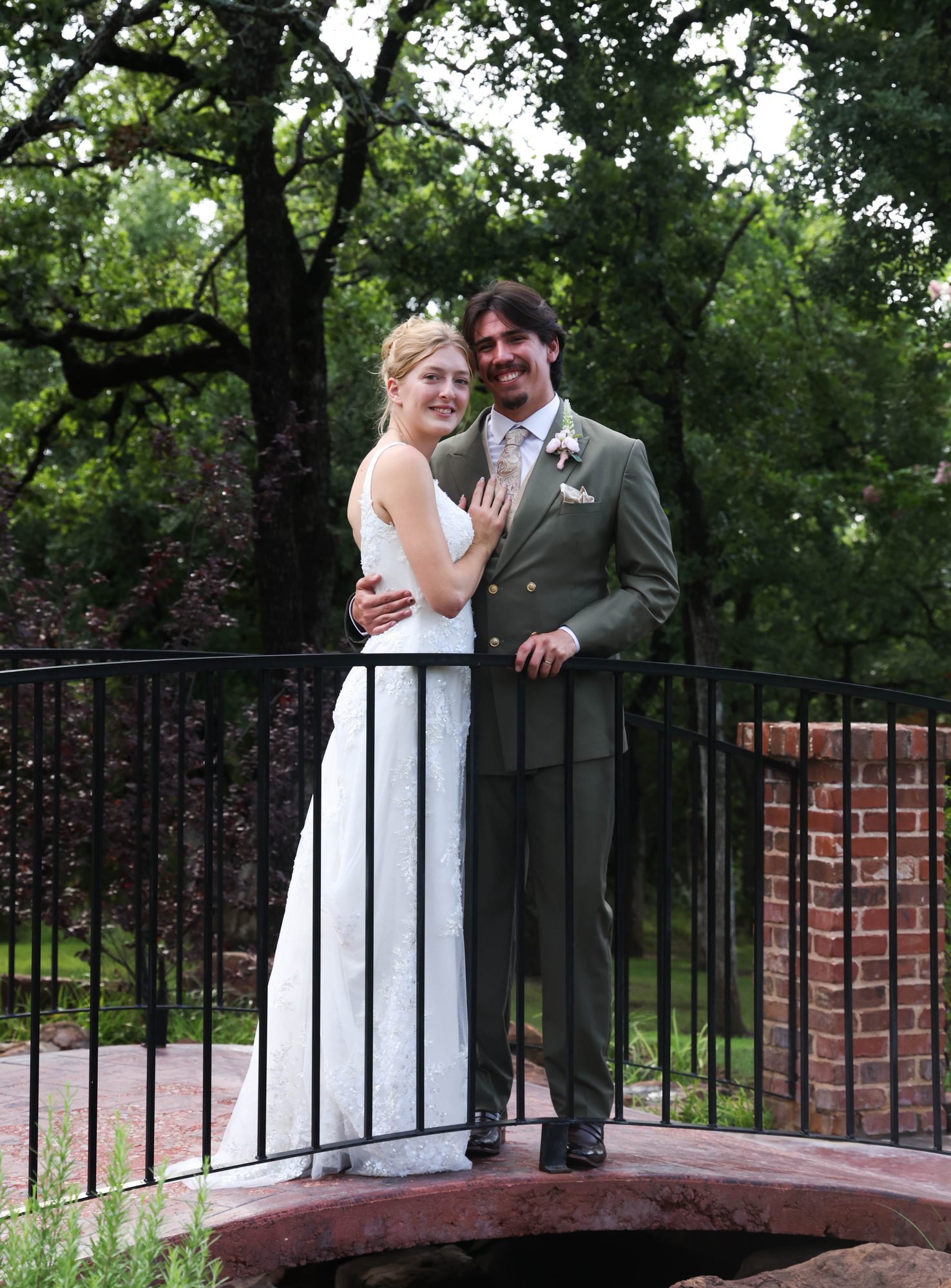 Bride and groom on a small garden bridge